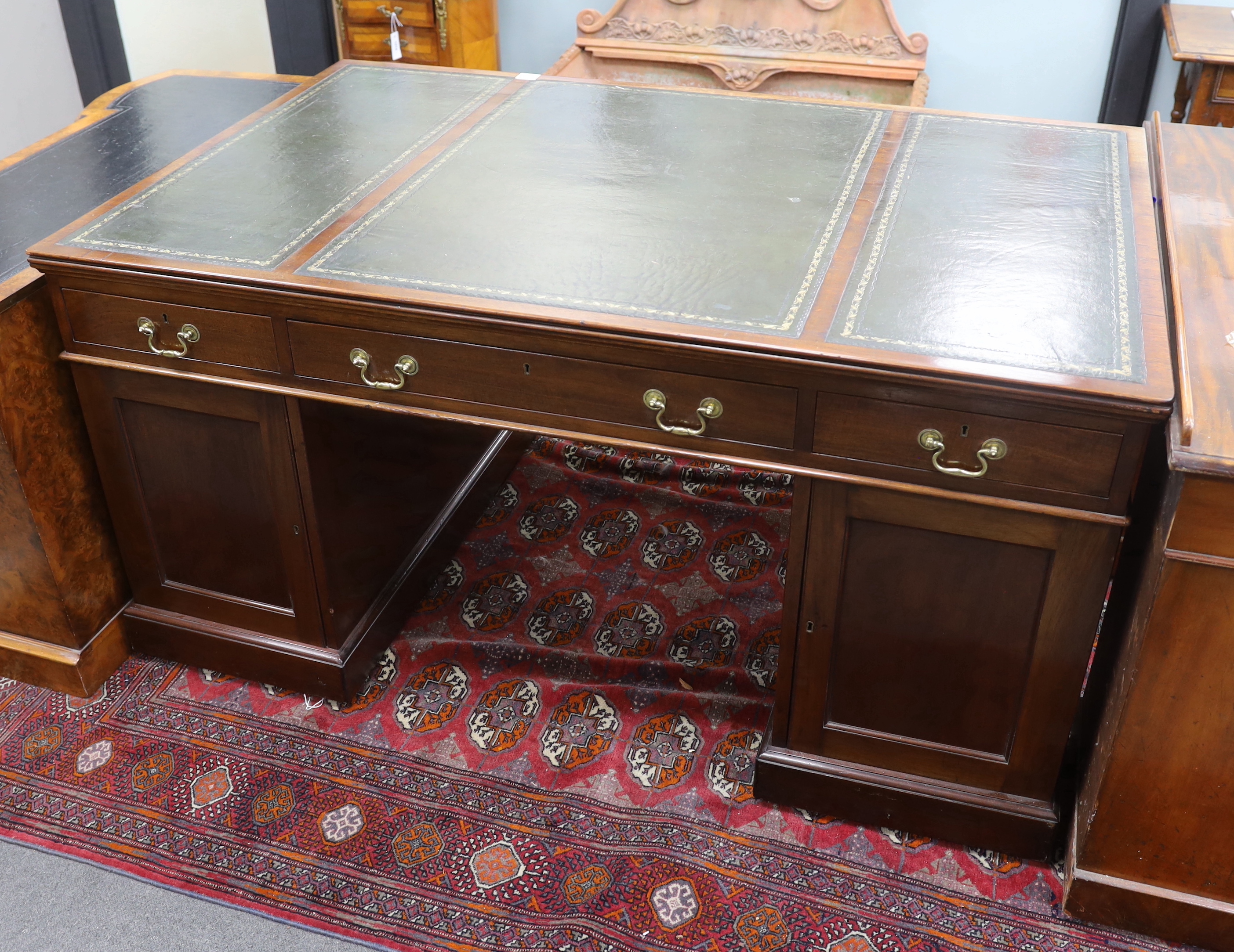 An early 20th century George III style mahogany pedestal partner's desk, width 152cm, depth 98cm, height 78cm